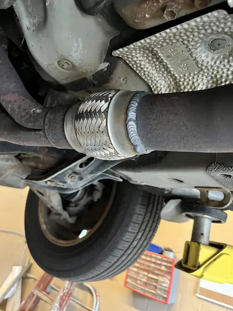 Exhaust flex section and converter under a vehicle from Parma