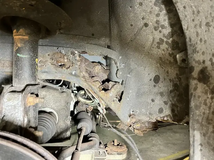 Rusted frame section before repair