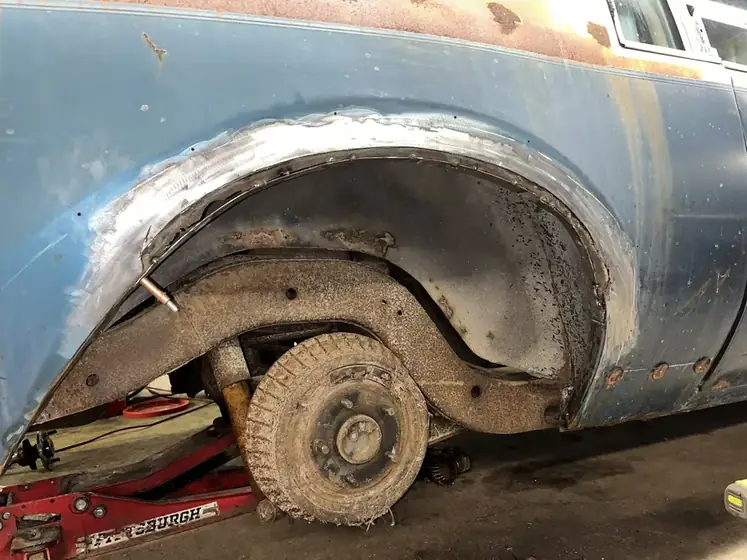 Vintage wheel arch cut back to bare metal