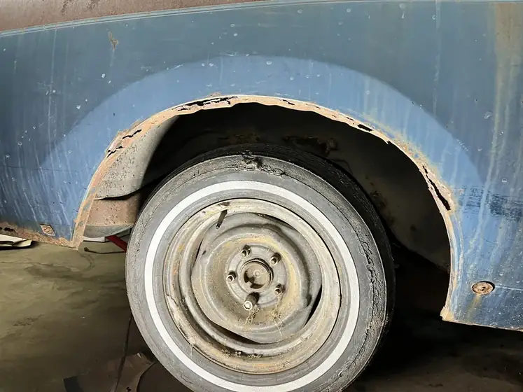 Wheel arch on a vintage vehicle before repair