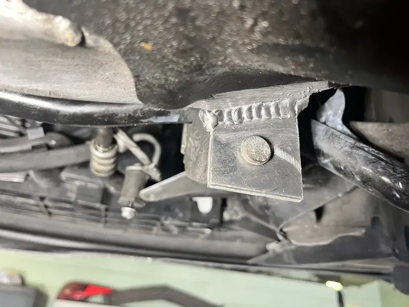 Welded bracket dressed back after the repair