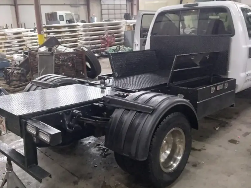 Chassis with a fabricated bed frame