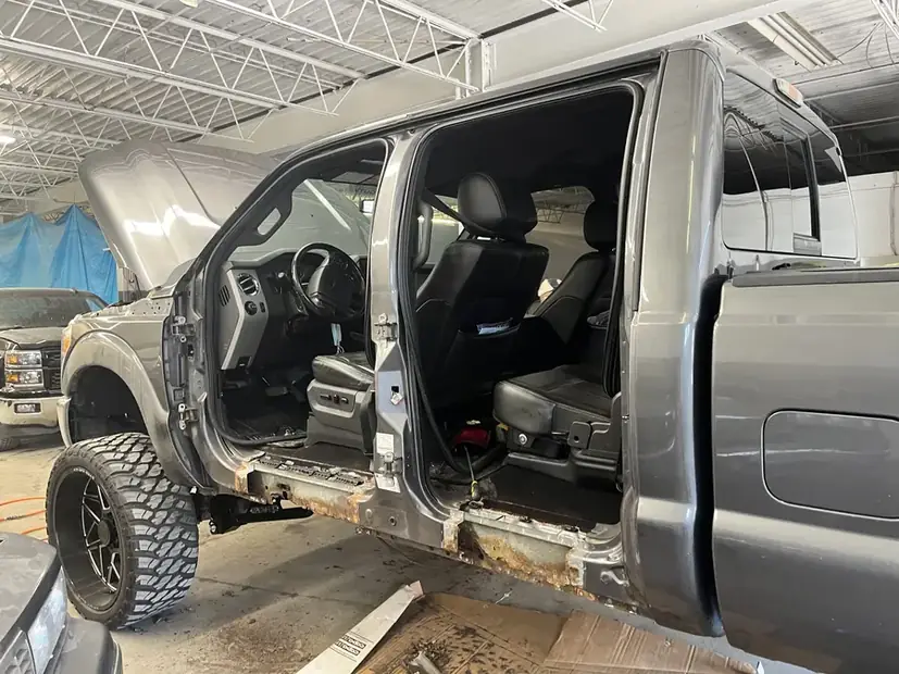 Truck cab with the door removed for alignment work