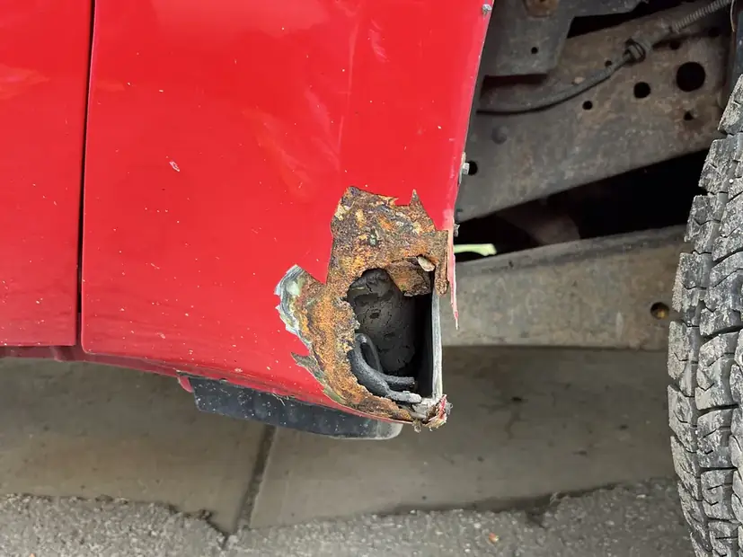 Hole in a body panel before a patch is welded in