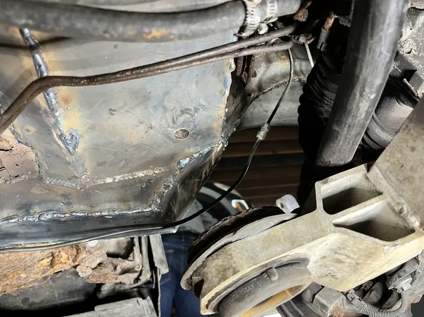 Corroded suspension mounting point before new steel is welded in