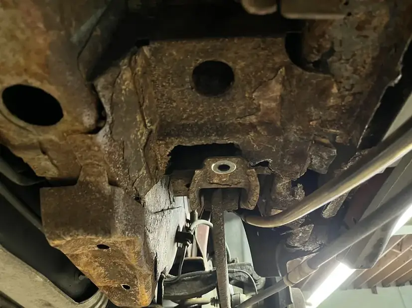 Trailing arm mount rusted through on a truck underbody