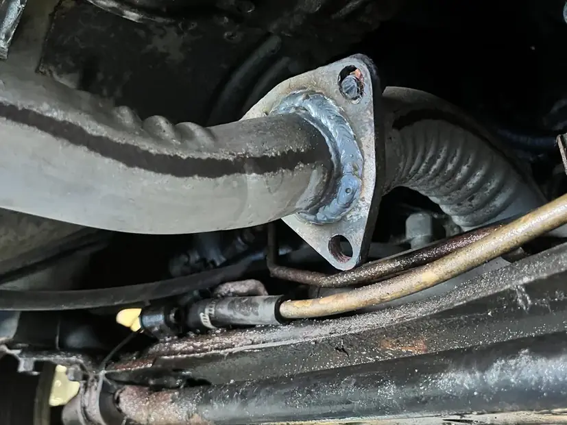 Exhaust hanger mount under a vehicle