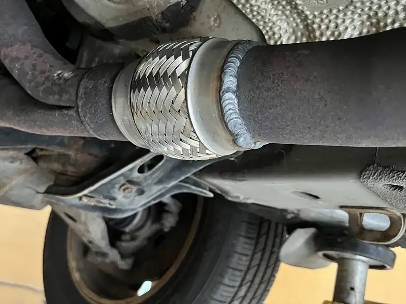 Flex joint and hanger under a vehicle