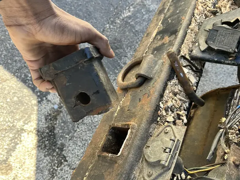Fabricated part held against the machine it was made for, on site