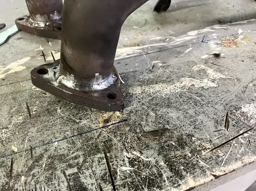 Exhaust manifold section removed and sitting on the shop floor