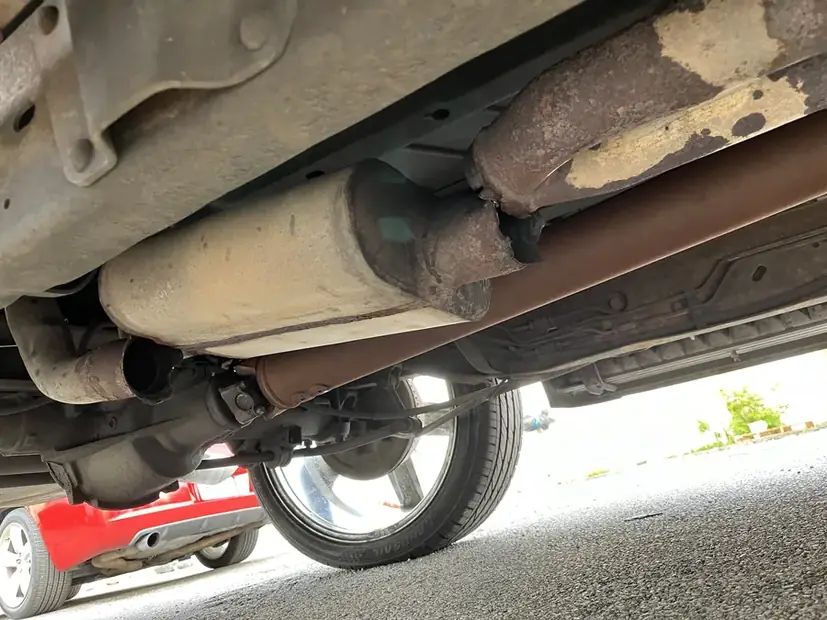 Rear muffler and tailpipe section under a vehicle