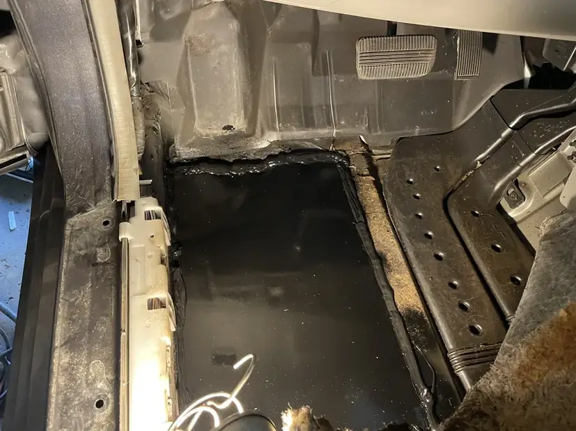 Floor pan stripped back to bare metal before patch work