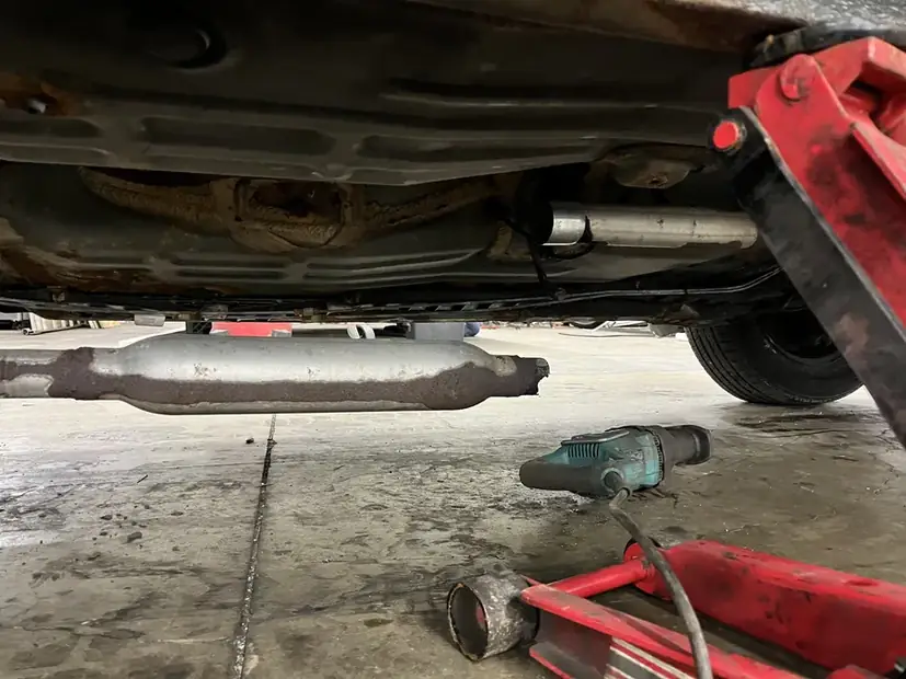 Muffler and rear section under a vehicle on the lift