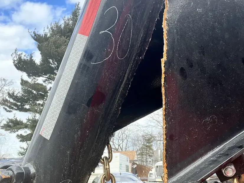 Rusted trailer body panel marked up before repair