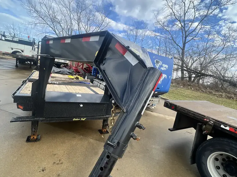 Gooseneck trailer in the yard with the ramps down
